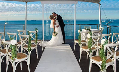 bride and groom kissing at wedding ceremony