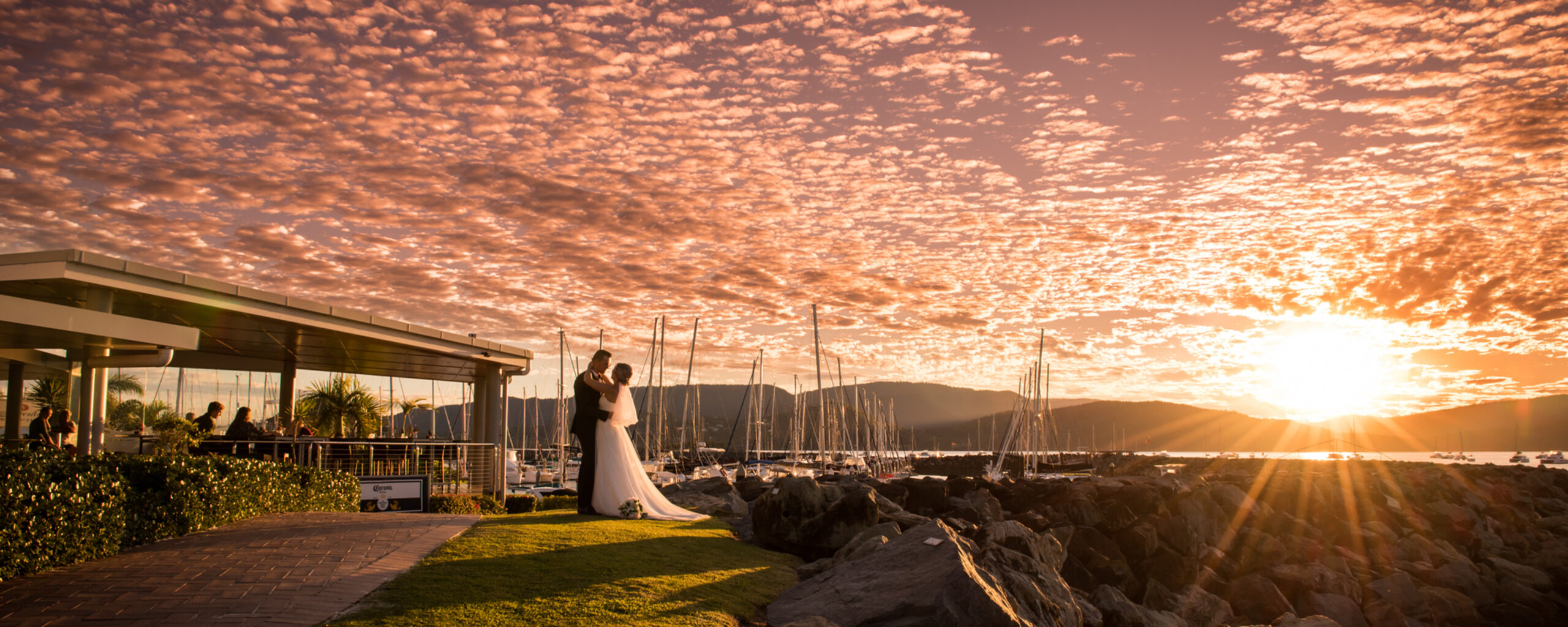 Bride and groom looking at sunset